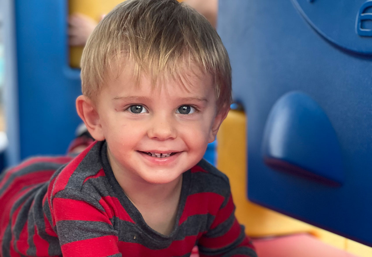 ocoee oaks preschool child smiling on playground set