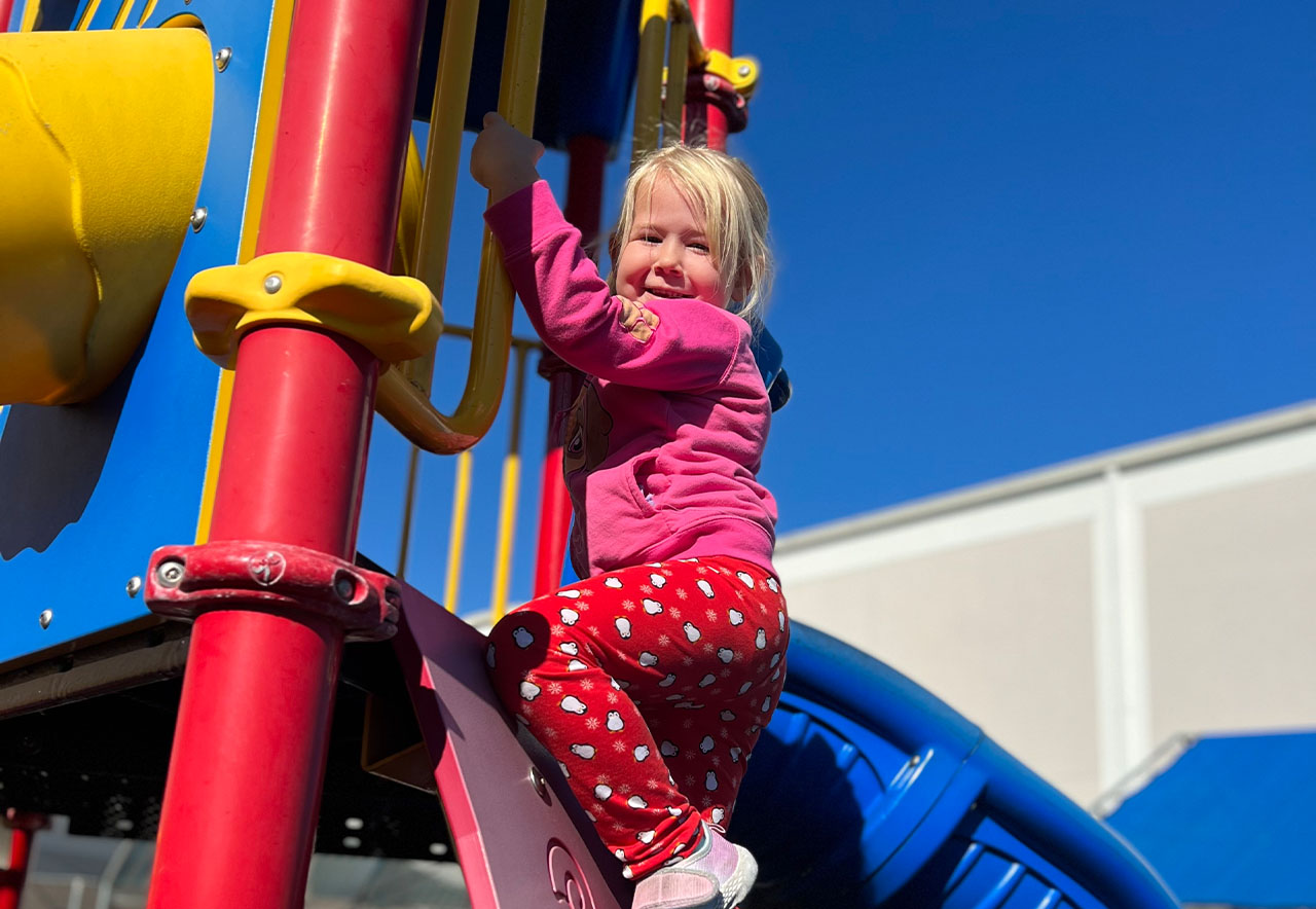 ocoee oaks preschool little girl climbing playground set