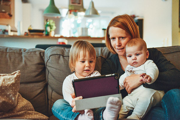 Mom and young children sitting on a couch