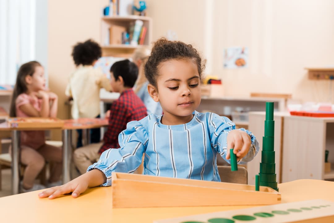 a kid playing with some blocks