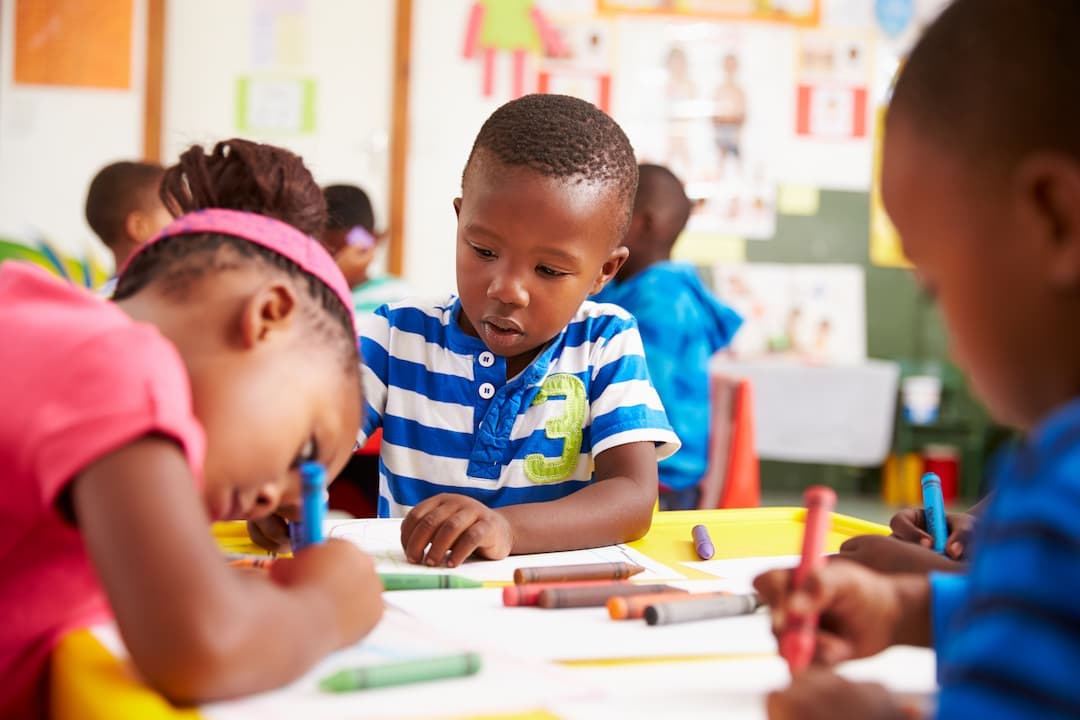 some kids coloring at a table