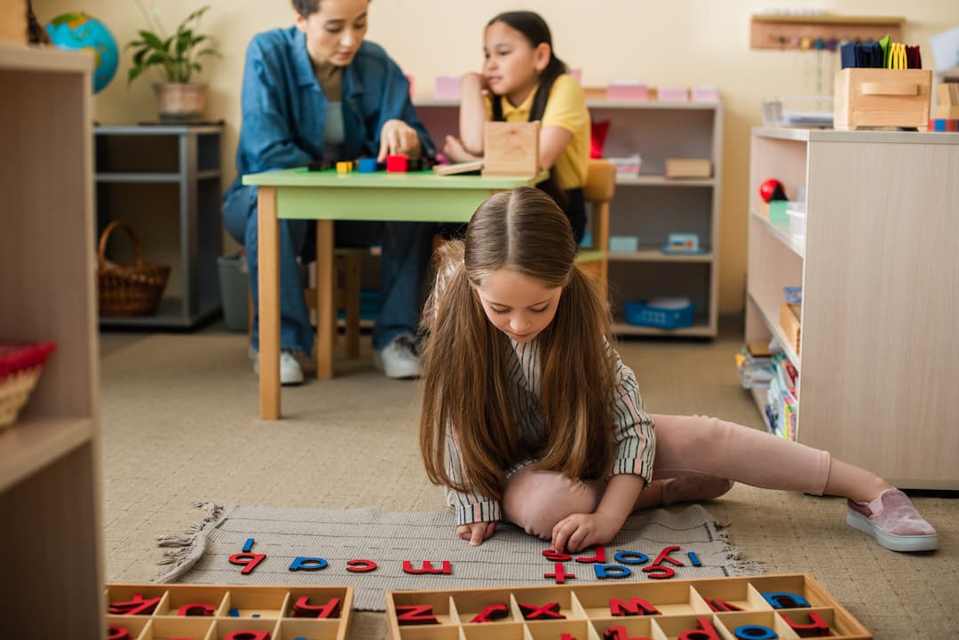 kids writing with wooden letters